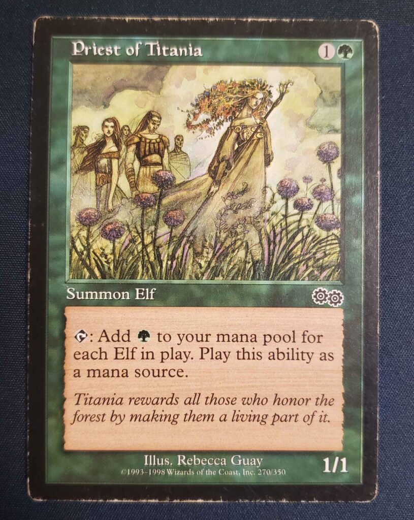 A moderately played Priest of Titania from Urza's Saga.