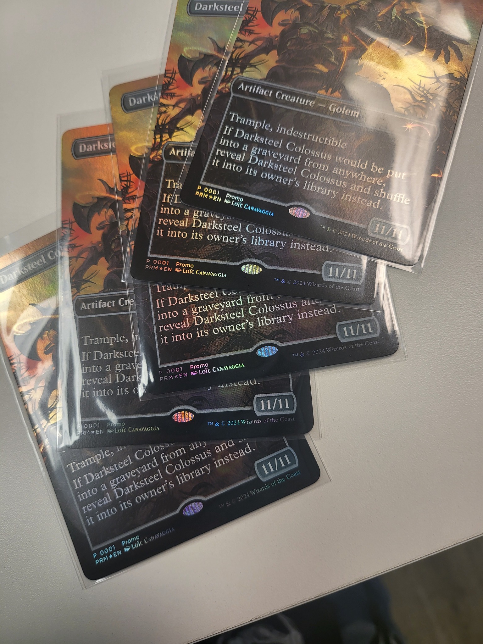 Multiple promotional copies of Darksteel Colossus with a misprint Upper Deck stamp where the Magic stamp should be. Photo credit: Jason Lannan