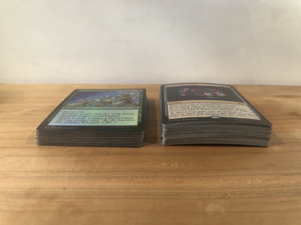 A stack of freshly opened Duskmourn and Bloomburrow foils opened within hours of each other.